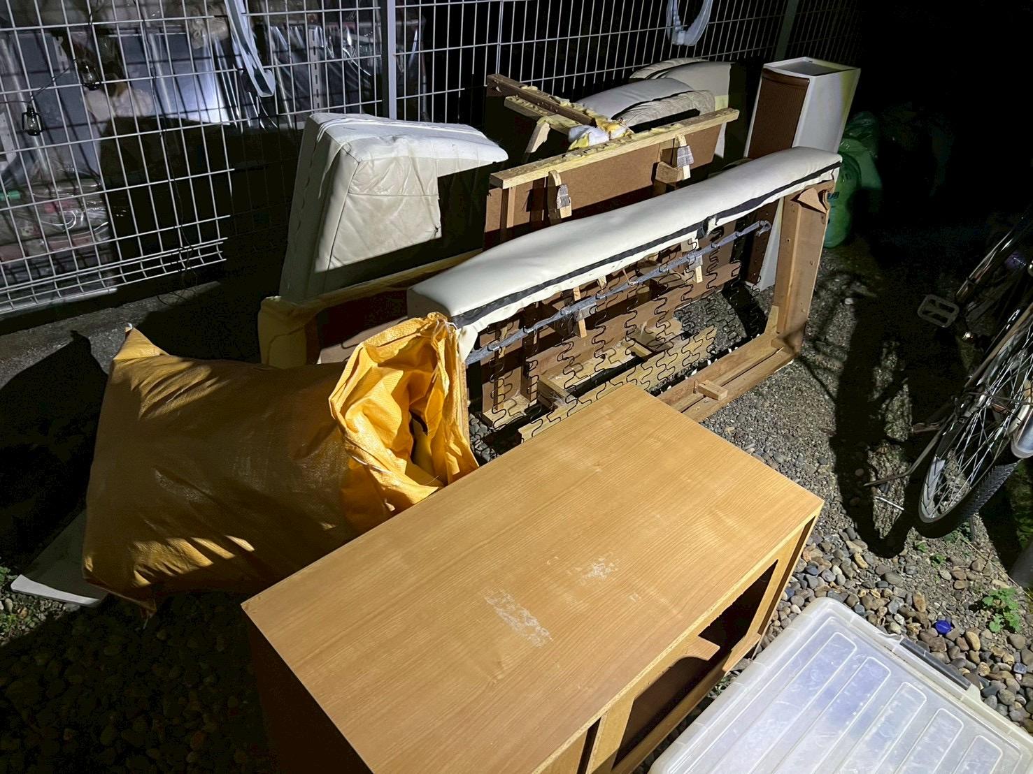 不用品回収前の屋外 家具や生活ゴミが庭に置かれている状態