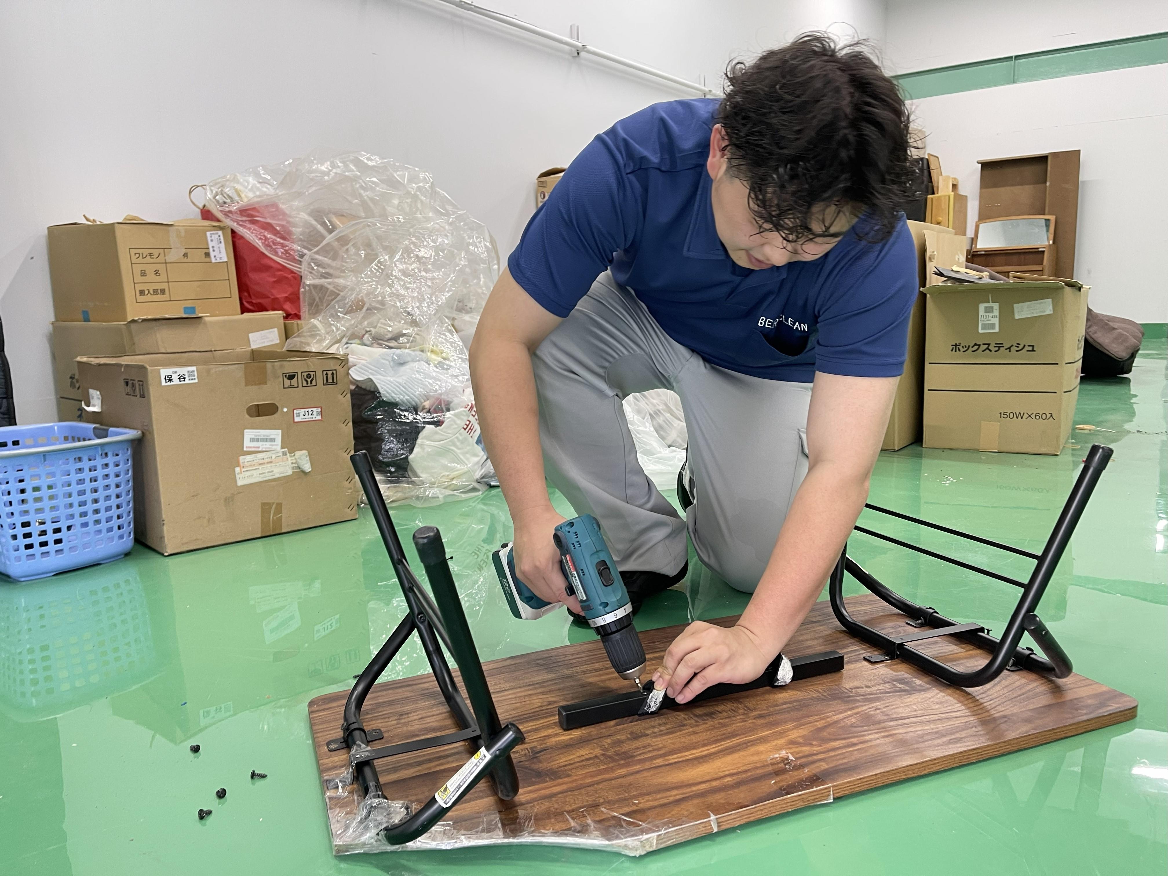 東京の不用品回収後、倉庫にてテーブルを解体しリサイクルをするベラクリーンスタッフの様子