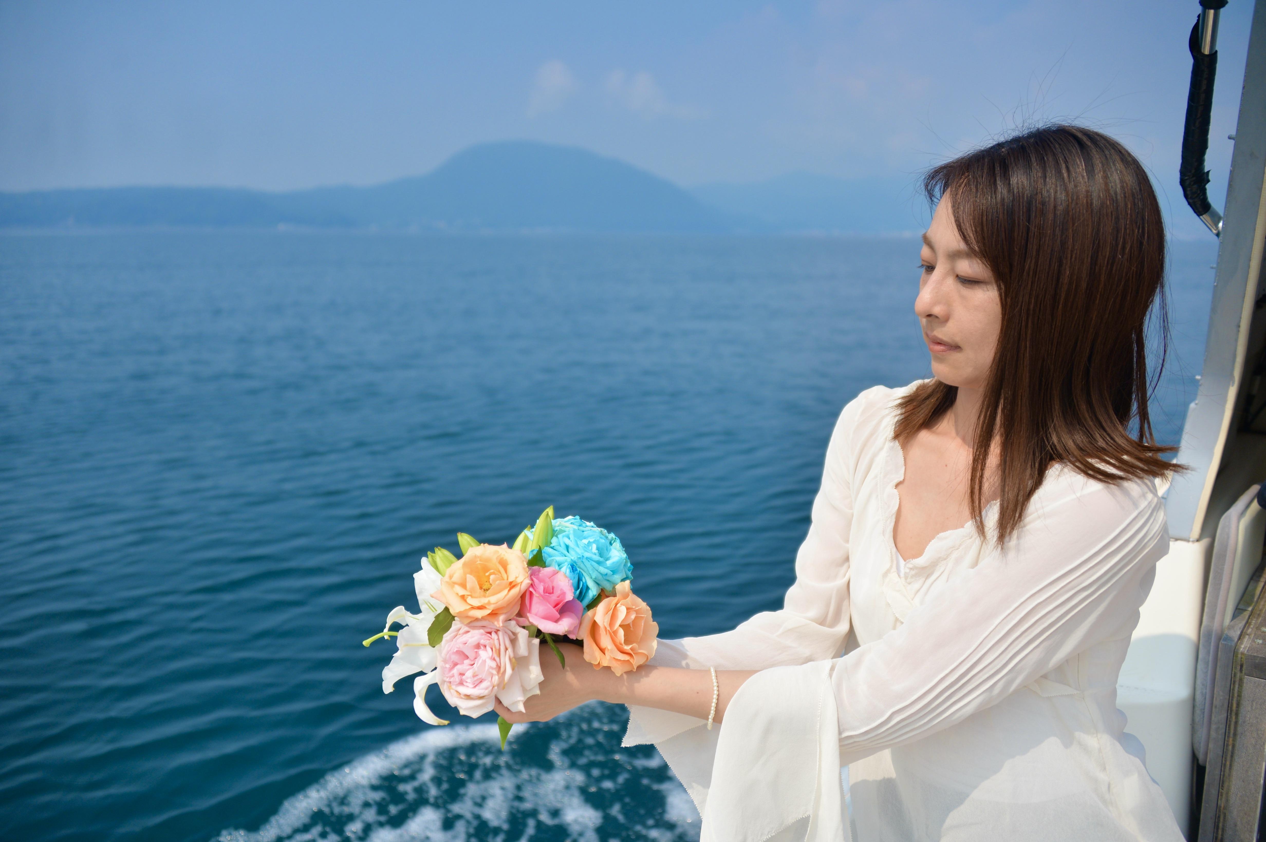 大分で海洋散骨永代供養祭で女性が献花する写真