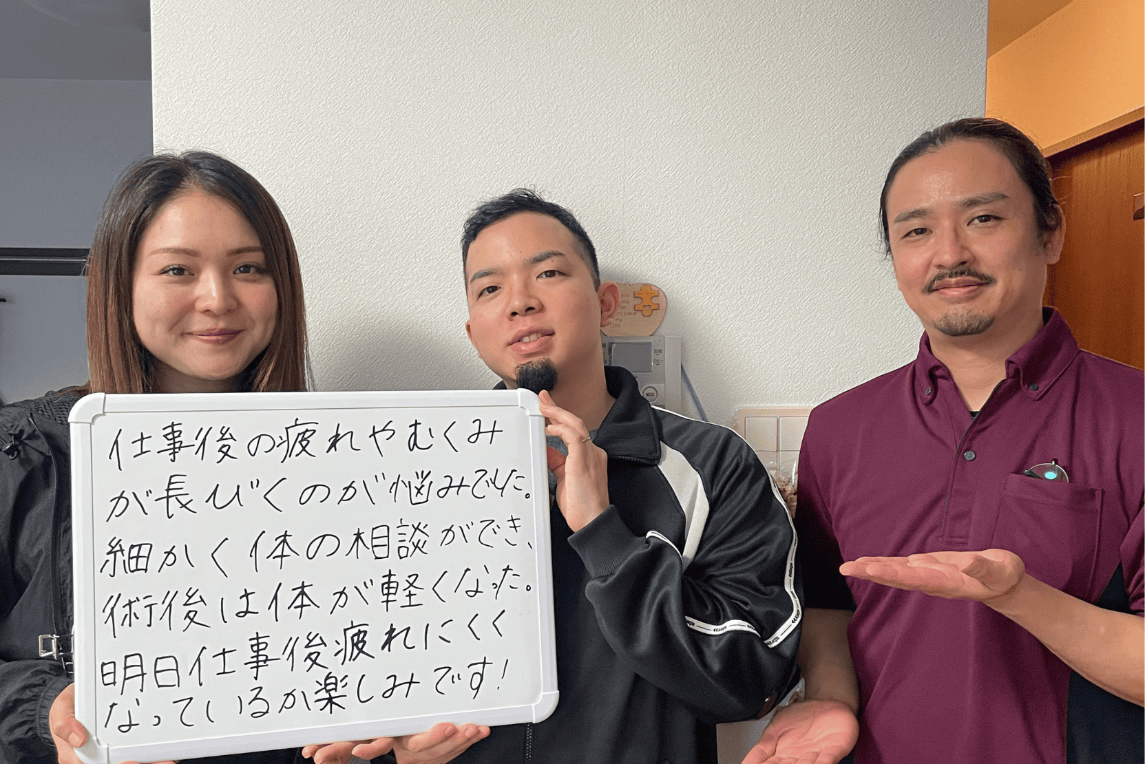 施術を受けた体が軽くなったと喜ぶご夫婦と出張整体パピル代表の下里が一緒に写っている写真