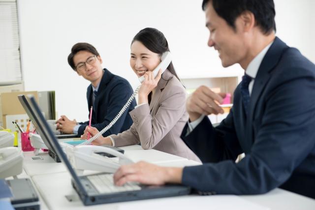People working and smiling in an office.