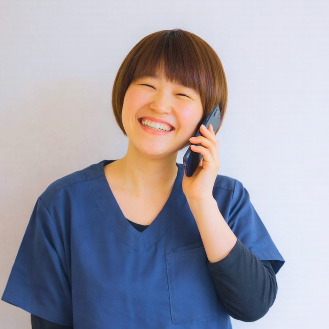 女性整体師が電話で予約に対応している様子