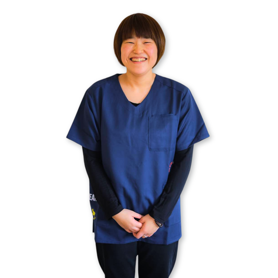 女性整体師が笑顔で立ち、丁寧にメッセージを伝えている様子