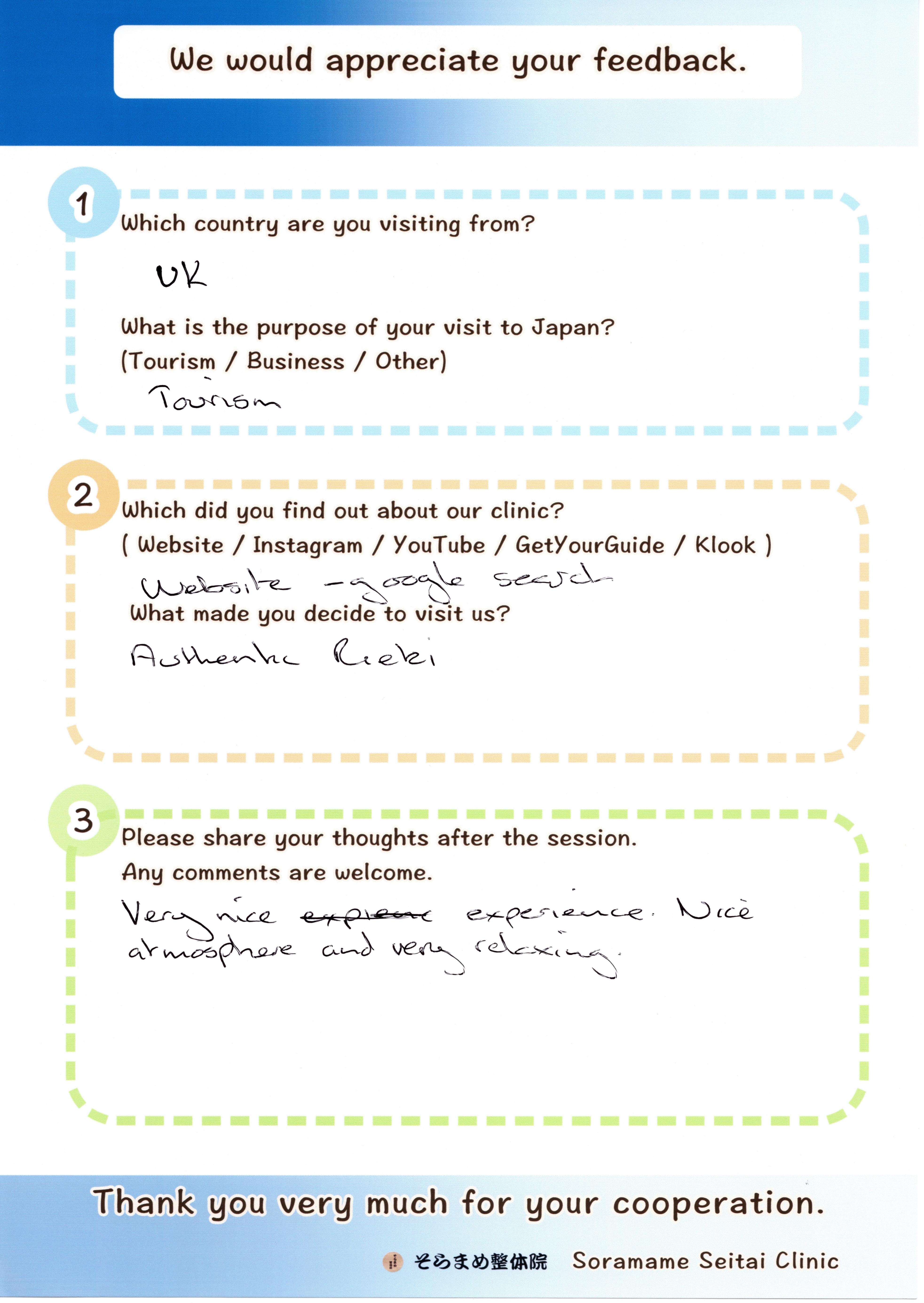Handwritten feedback form from an English guest, describing her relaxing Reiki experience and nice atmosphere.