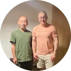 Soramame Chiropractic Clinic practitioner with a male guest from Germany, both smiling warmly after a Reiki healing session.