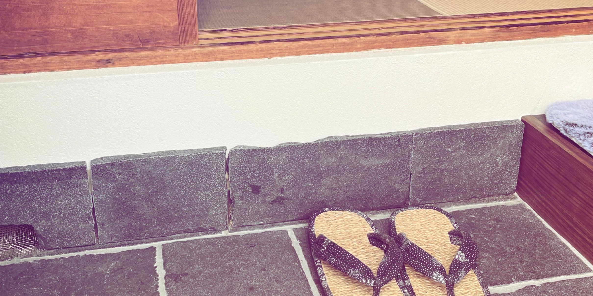 Traditional Japanese entrance with tatami room and zori sandals