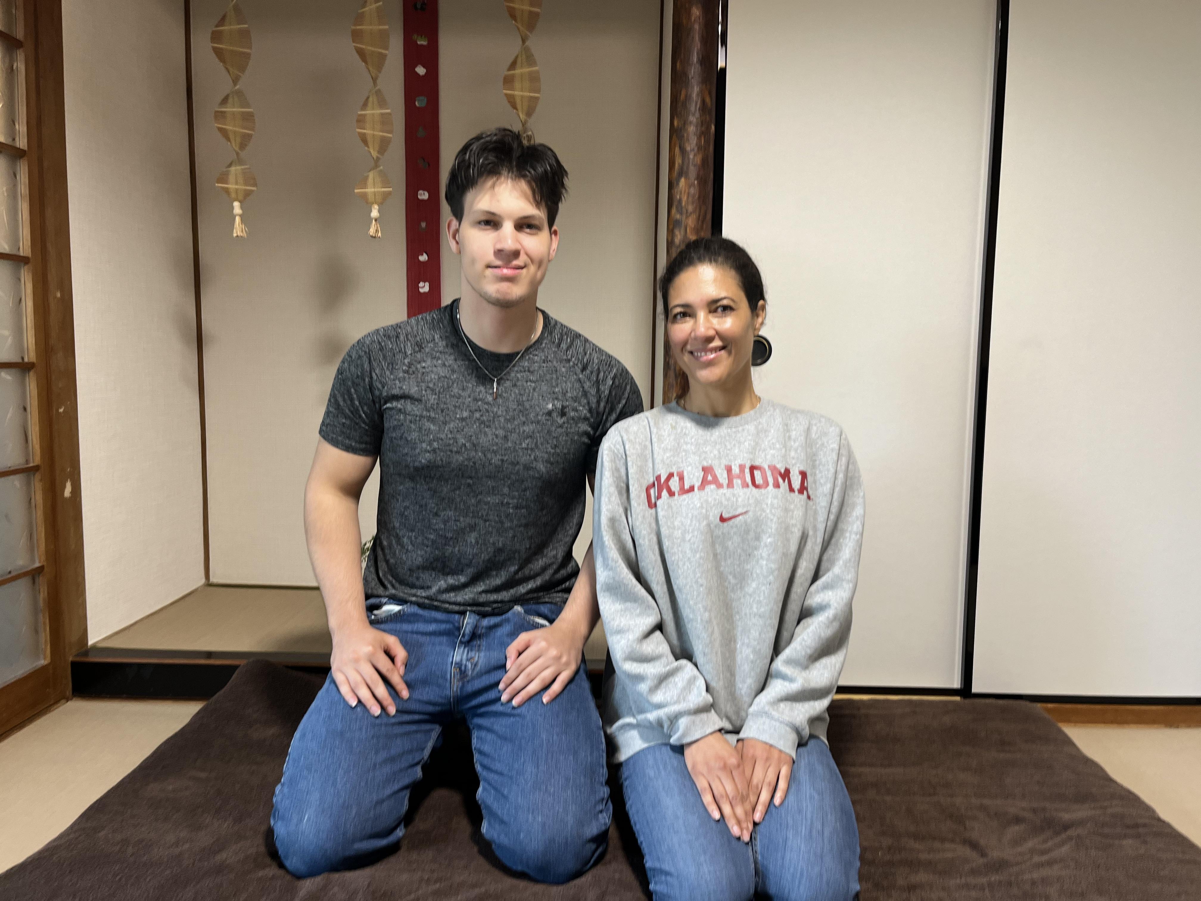 A commemorative photo of an English couple sitting in a Japanese tatami room after their Usui Reiki session at Soramame Seitai Clinic.