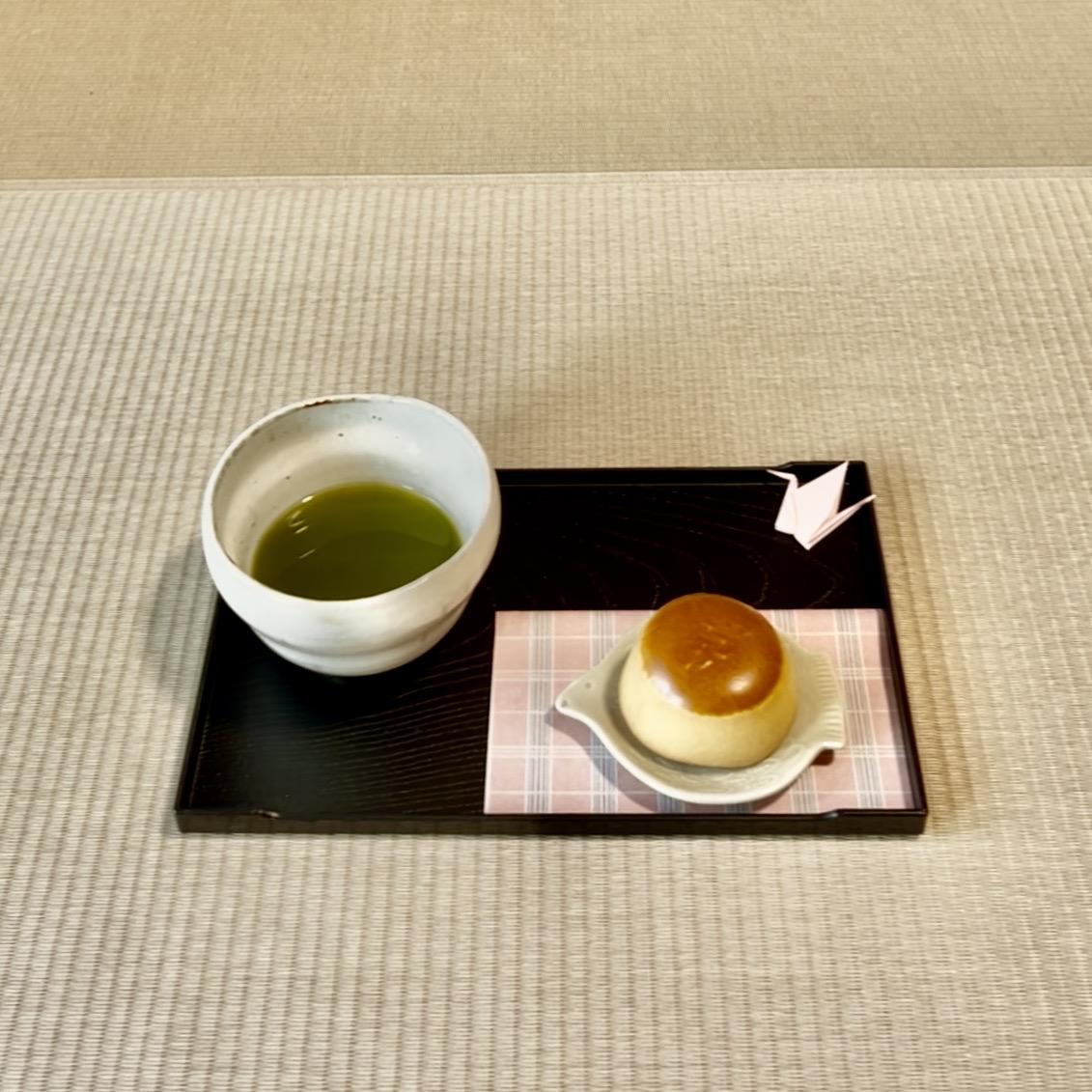 Premium Matcha green tea and a seasonal wagashi sweet served on a traditional tray in a serene tatami room.